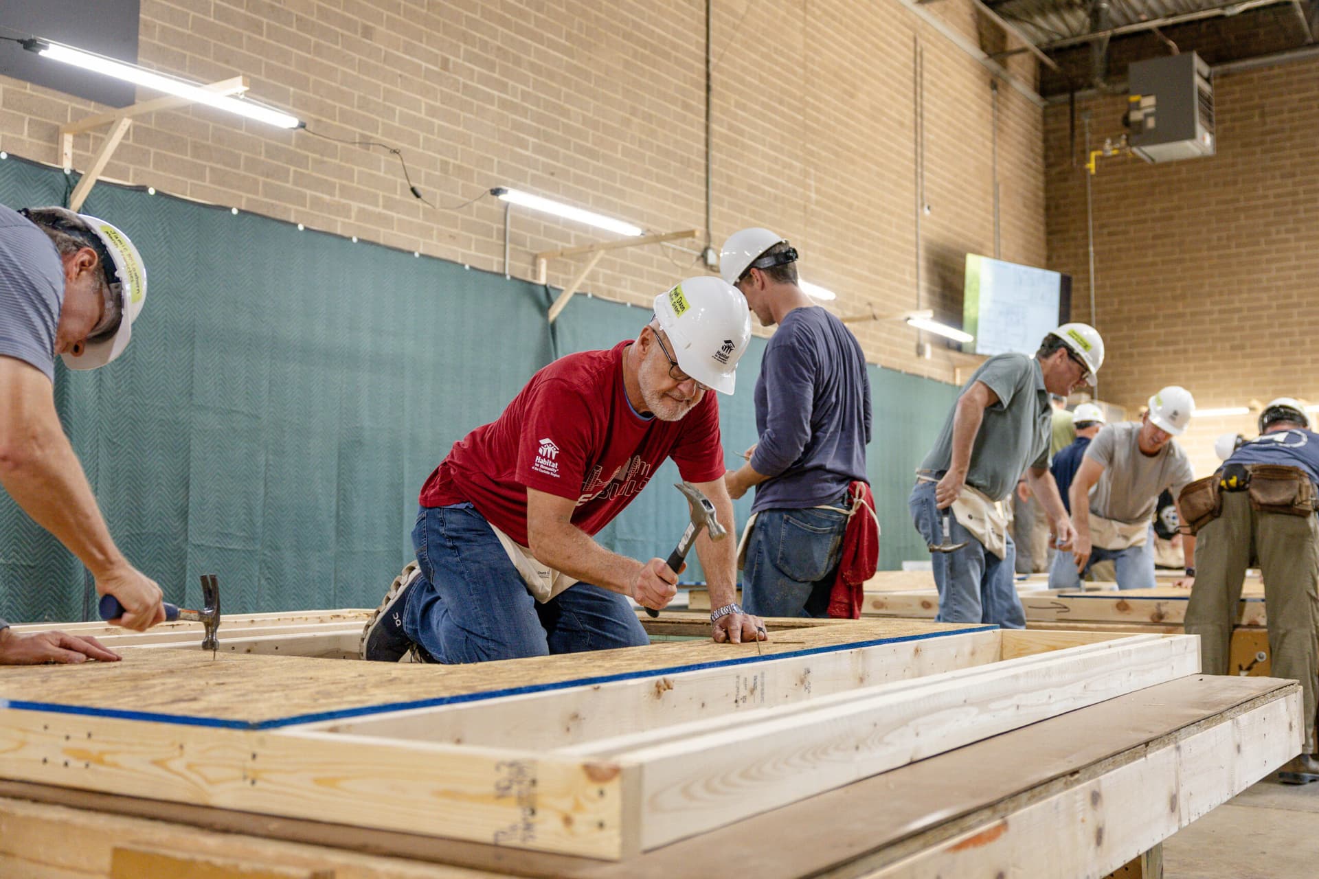 2026 CEO Build volunteering using a hammer