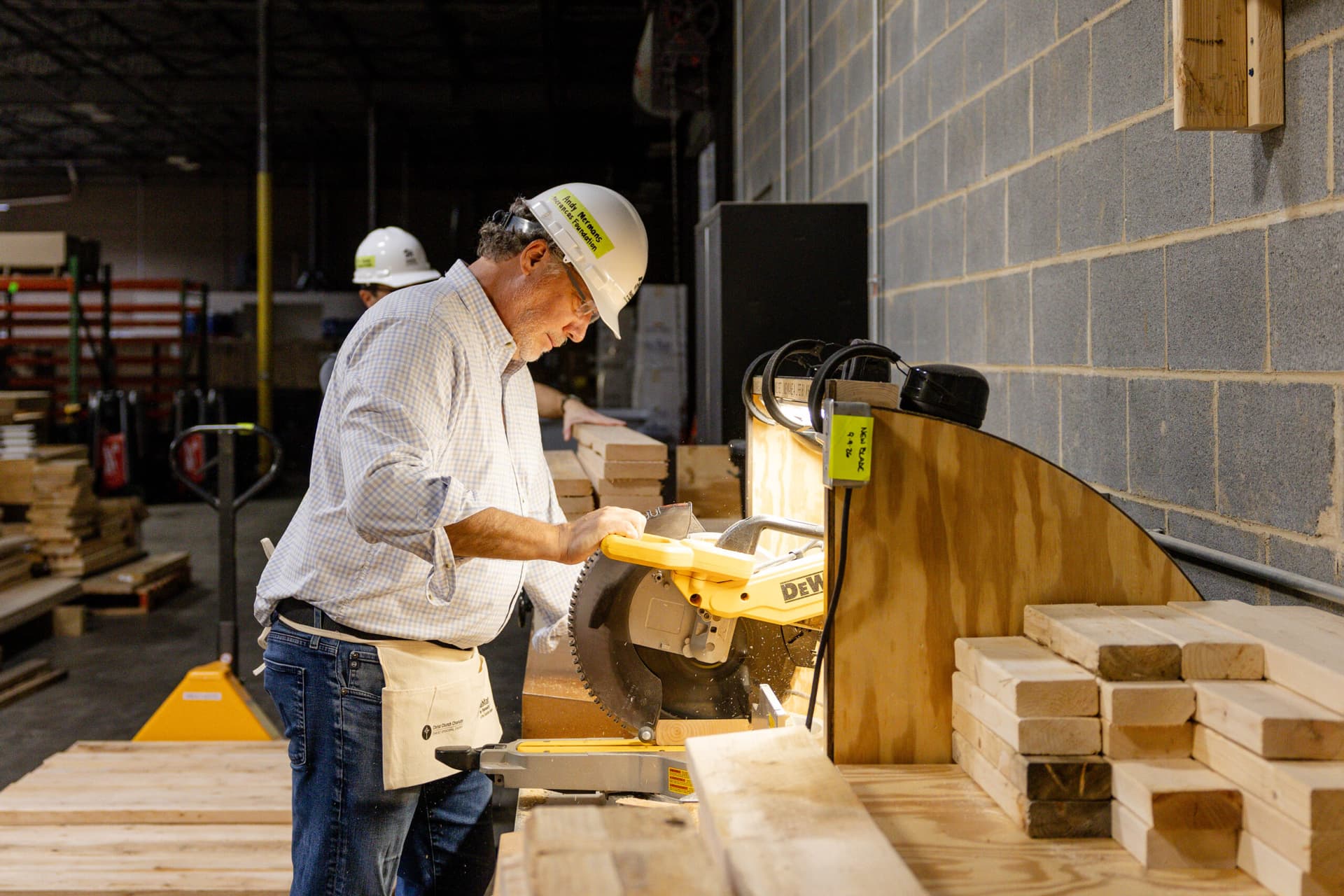 2026 CEO Build Chair, Andy Mermans, sawing wood
