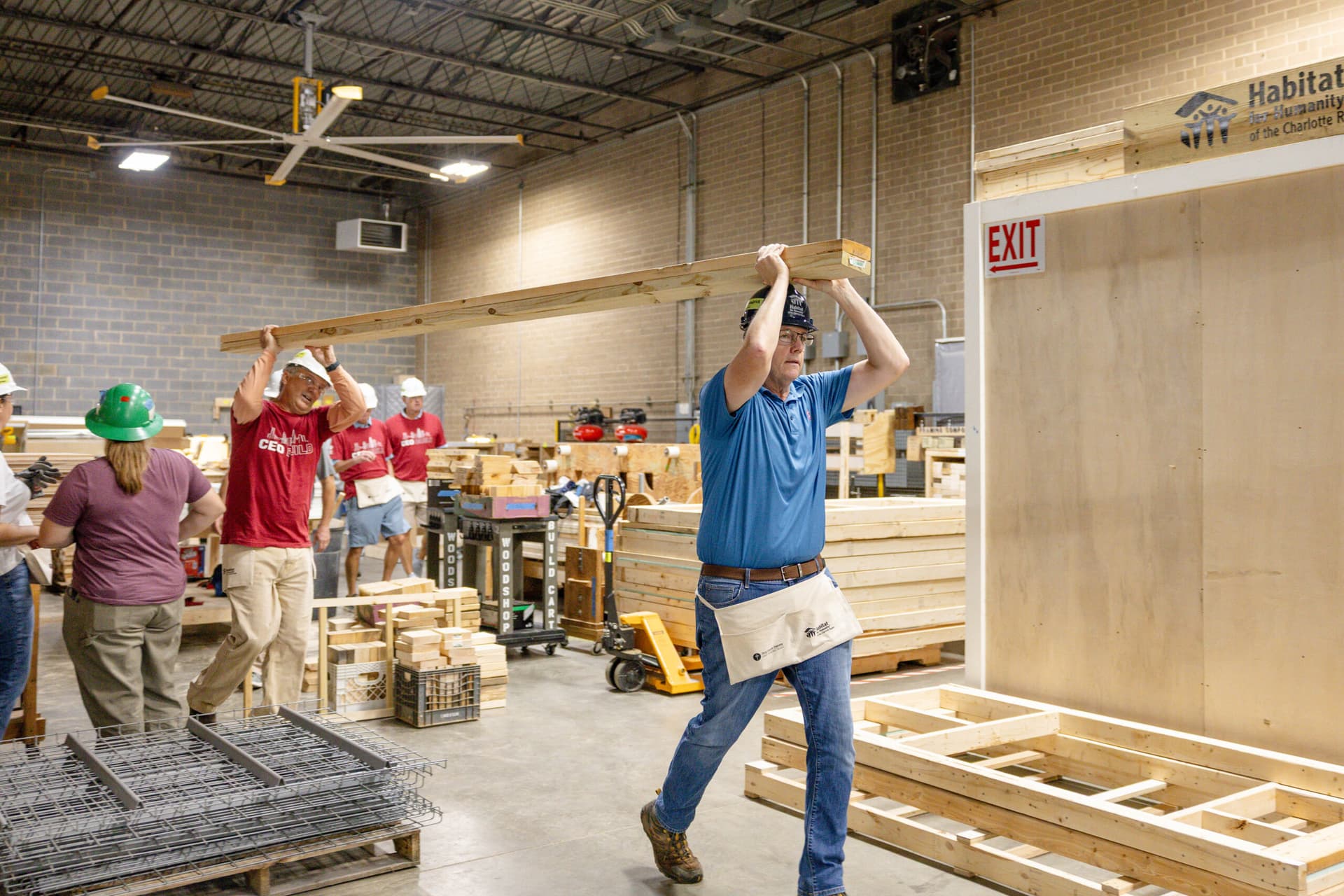 2026 CEO Build Volunteers carrying building materials