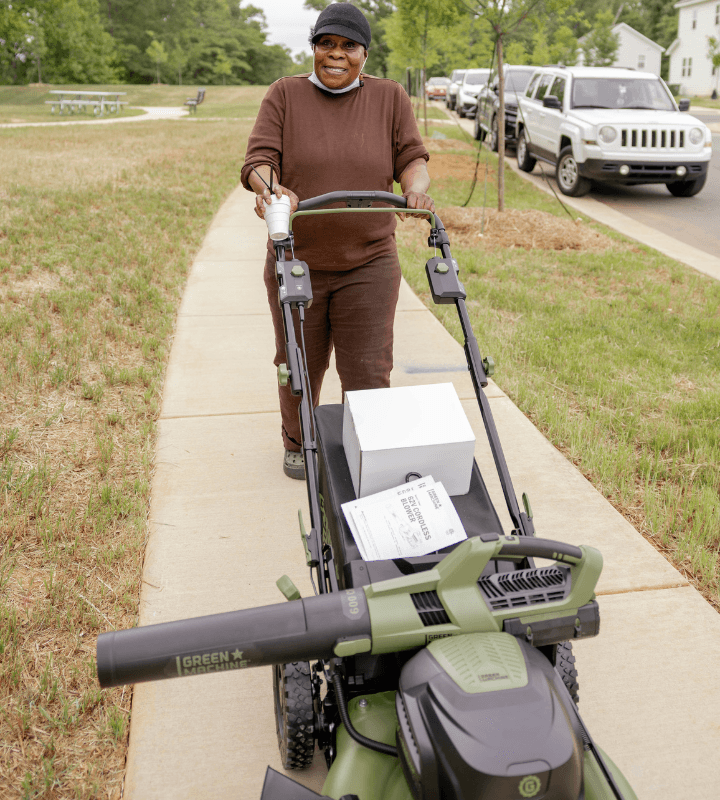 homeowner pushing lawn mower