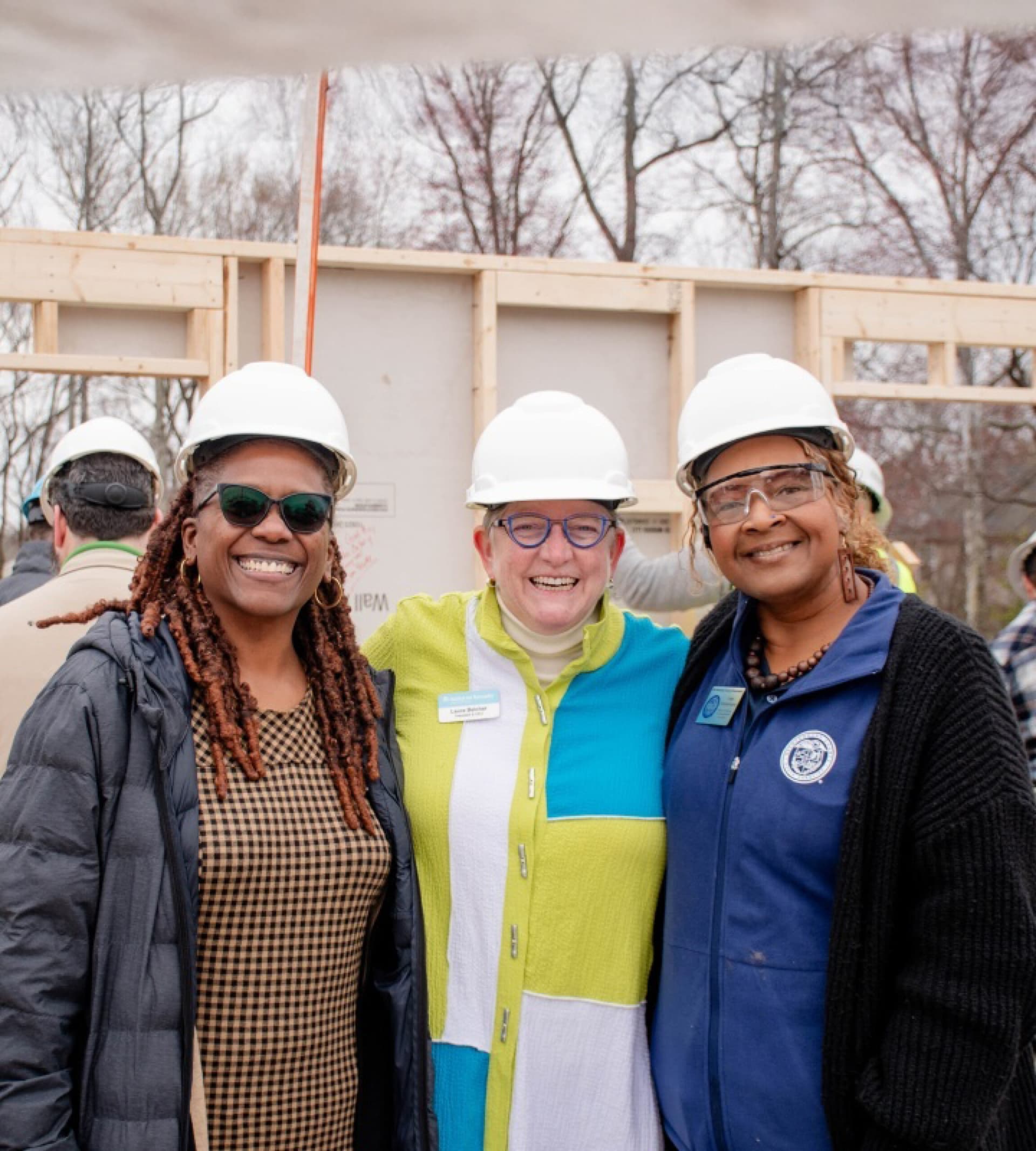Volunteers standing together in front of an unbuilt home